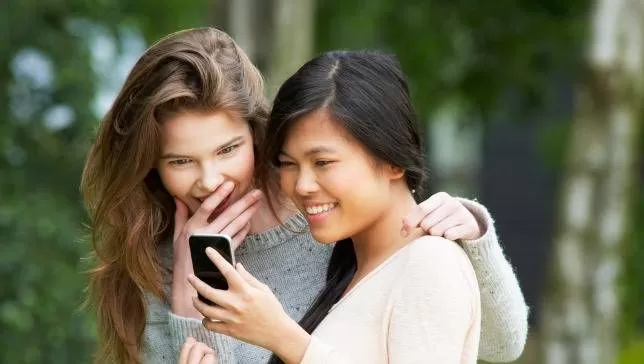 Two women reading a text